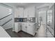 White kitchen cabinets, gray tile backsplash, and quartz countertops at 2680 Andes Dr, Statesville, NC 28625