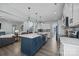 Modern kitchen with white cabinets, gray backsplash, and a blue island at 2680 Andes Dr, Statesville, NC 28625