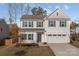 Two-story house with beige vinyl siding, gray trim, and a two-car garage at 2680 Andes Dr, Statesville, NC 28625