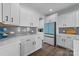 Modern kitchen with white cabinets, gray backsplash, and a blue island at 2680 Andes Dr, Statesville, NC 28625