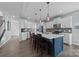 Modern kitchen with white cabinets, gray backsplash, and a blue island at 2680 Andes Dr, Statesville, NC 28625