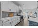 Modern kitchen with white cabinets, gray backsplash, and a blue island at 2680 Andes Dr, Statesville, NC 28625
