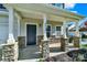 Front porch with stone pillars and a dark-colored front door at 2013 Firefly Ln, Fort Mill, SC 29715