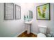 Clean and modern bathroom with pedestal sink and stylish wall art at 3668 Charles Nw St, Conover, NC 28613