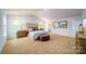 Spacious bedroom with carpeted floor, large bed, and ample natural light at 3668 Charles Nw St, Conover, NC 28613