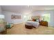 Main bedroom with tufted headboard, plush carpet, and plenty of natural light at 3668 Charles Nw St, Conover, NC 28613