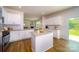 Spacious kitchen with island, white cabinets, and access to backyard at 3668 Charles Nw St, Conover, NC 28613