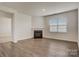 Bright living room featuring a corner fireplace and hardwood floors at 3692 Charles Nw St, Conover, NC 28613