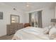 Bedroom with queen bed, dresser and access to balcony at 1315 East Blvd # 408, Charlotte, NC 28203
