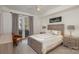 Bright bedroom with a queen-size bed and access to a balcony at 1315 East Blvd # 408, Charlotte, NC 28203