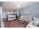 Living room with open kitchen, light sofa, and ceiling fan at 1315 East Blvd # 408, Charlotte, NC 28203