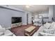 Spacious living room with modern furniture and a large TV at 1315 East Blvd # 408, Charlotte, NC 28203