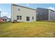 Tan house with grassy backyard and patio at 8059 Plymouth Dr, Sherrills Ford, NC 28673