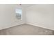 Unfurnished bedroom with plush carpeting and a large window at 8063 Plymouth Dr, Sherrills Ford, NC 28673