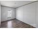 Simple bedroom featuring hardwood floors and a window at 229 Sailwinds Rd, Mooresville, NC 28115