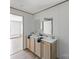 Bathroom with double vanity and light wood cabinets at 229 Sailwinds Rd, Mooresville, NC 28115