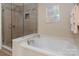 Bathroom with shower and tub, updated tile and fixtures at 45014 Wigeon Ln # 100, Indian Land, SC 29707