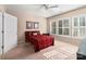 Cozy bedroom with a red bedspread and plenty of natural light at 45014 Wigeon Ln # 100, Indian Land, SC 29707