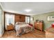 Main bedroom with wood-paneled accent wall and hardwood floors at 4677 Ramsey Rd, Sharon, SC 29742