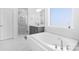 Elegant bathroom with soaking tub, shower, and gray vanity at 16203 Tulloch Rd, Charlotte, NC 28278