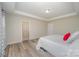Primary bedroom with ensuite bathroom and wood-look flooring at 3057 Burnello Ct, Iron Station, NC 28080
