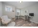 Home office featuring wood-look flooring, a desk, and comfortable chair at 3057 Burnello Ct, Iron Station, NC 28080