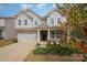 Two-story gray house with stone accents and a two-car garage at 3057 Burnello Ct, Iron Station, NC 28080