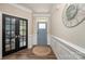 Bright entryway with stylish light fixture and wood floors at 3057 Burnello Ct, Iron Station, NC 28080