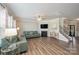 Light-filled living room with fireplace and hardwood floors at 3057 Burnello Ct, Iron Station, NC 28080