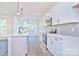 Bright kitchen with white cabinets and gray tile backsplash at 201 Wedge View Way, Statesville, NC 28677