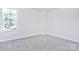 Simple bedroom with a window and neutral carpet at 201 Wedge View Way, Statesville, NC 28677