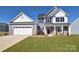 Two-story home with gray and white siding, two-car garage at 201 Wedge View Way, Statesville, NC 28677