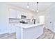 White kitchen with center island and gray tile backsplash at 201 Wedge View Way, Statesville, NC 28677