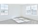 Well-lit bedroom with two large windows and carpet at 201 Wedge View Way, Statesville, NC 28677