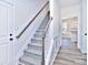 Stylish staircase with grey carpet runner and wooden handrail at 205 Wedge View Way, Statesville, NC 28677