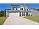 Two-story house with gray siding, white double door garage, and manicured lawn at 205 Wedge View Way, Statesville, NC 28677