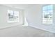 Bright bedroom with grey carpet and two windows at 103 Bunker Hill Ln, Statesville, NC 28677