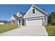 Gray house with white garage door and landscaping at 103 Bunker Hill Ln, Statesville, NC 28677