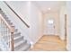 Bright entryway with stairs, wood-look floors, and access to a half-bath at 103 Bunker Hill Ln, Statesville, NC 28677