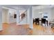 Bright dining room features hardwood floors and a view of the kitchen and staircase at 6416 Red Maple Dr, Charlotte, NC 28277