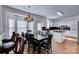 Eat-in kitchen with dark wood table and chairs, granite counters, and white cabinets at 6416 Red Maple Dr, Charlotte, NC 28277