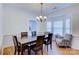 Bright dining room with large table, chairs, and bay window at 6416 Red Maple Dr, Charlotte, NC 28277