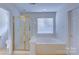 Bathroom with shower/tub combo, and a window with blinds at 6416 Red Maple Dr, Charlotte, NC 28277