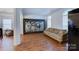 Living room with hardwood floors, large artwork and comfy couch at 6416 Red Maple Dr, Charlotte, NC 28277