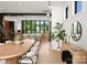 Bright dining room with large wood table and modern white chairs, open to kitchen and living areas at 5447 Topping Pl # 103, Charlotte, NC 28209