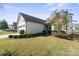 One-story house with light beige siding, a two-car garage, and landscaping at 233 Grovefield Dr, Fort Mill, SC 29715