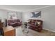 Living room with brown leather sofas and hardwood floors at 2009 Stoney Point Ln # 24, Charlotte, NC 28210