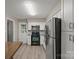 Kitchen boasts white cabinets, stainless steel appliances, and wood flooring at 2009 Stoney Point Ln # 24, Charlotte, NC 28210