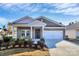 Brick ranch home with 2-car garage and landscaped front yard at 7403 American Elm Rd, Charlotte, NC 28215