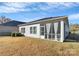 Home exterior showcasing a screened porch and backyard at 7403 American Elm Rd, Charlotte, NC 28215